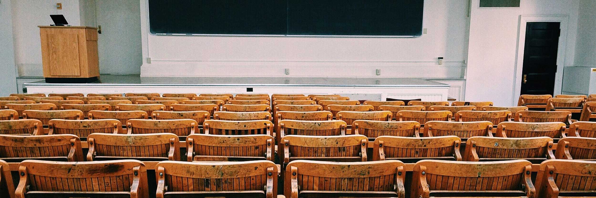 Rows of chairs awaiting students in a university lecture hall